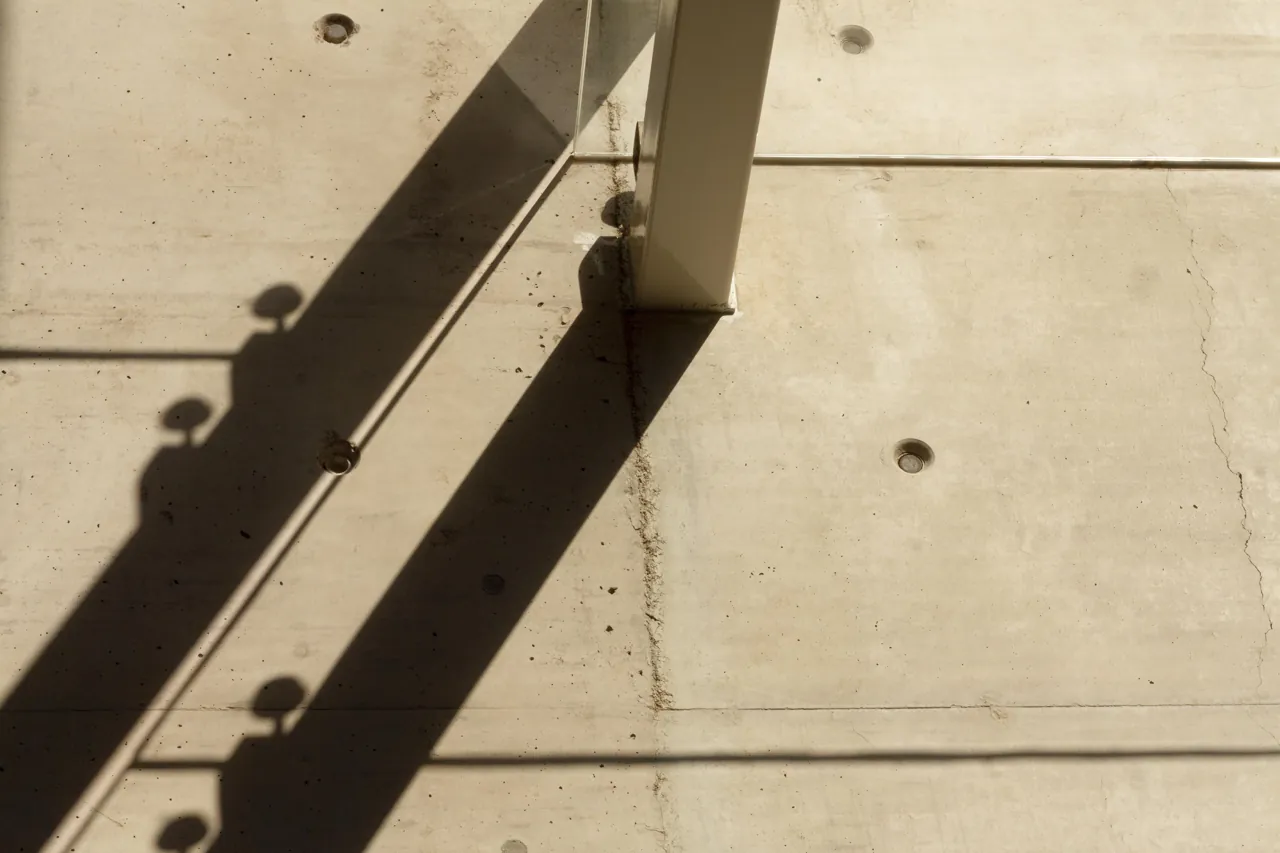 Sunlight and shadows across a concrete architectural surface